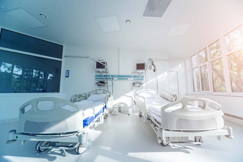 Modern hospital ward with patient beds and monitors